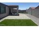 Spacious backyard featuring turf grass, a covered patio, and desert landscaping at 1418 E Jacqueline Pl, Casa Grande, AZ 85122