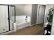 Well-lit bathroom showcasing a soaking tub and a glass-enclosed shower at 1418 E Jacqueline Pl, Casa Grande, AZ 85122