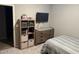 Neutral bedroom with contemporary furniture, a mounted TV, and carpeted floor offering a comfortable and stylish space at 1418 E Jacqueline Pl, Casa Grande, AZ 85122