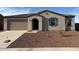 Single-level home featuring a low-maintenance front yard, a two-car garage, and an arched entryway at 1418 E Jacqueline Pl, Casa Grande, AZ 85122