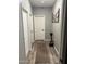 Hallway with a decorative rug, gray walls, and several white doors with black hardware at 1418 E Jacqueline Pl, Casa Grande, AZ 85122