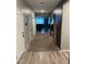 Hallway with hardwood floors and neutral gray walls, leading to the living area with modern décor at 1418 E Jacqueline Pl, Casa Grande, AZ 85122