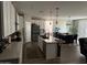 Open-concept kitchen featuring white cabinets, an island with a sink, and stainless steel appliances at 1418 E Jacqueline Pl, Casa Grande, AZ 85122