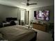 Spacious main bedroom featuring modern decor, ceiling fan, and an entertainment center with a large-screen television at 1418 E Jacqueline Pl, Casa Grande, AZ 85122