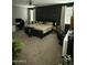 Main bedroom with a large bed, gray walls, carpet flooring, and a ceiling fan at 1418 E Jacqueline Pl, Casa Grande, AZ 85122