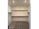 Empty walk-in closet with shelving and carpeted floor, providing ample storage space and an organized design at 1418 E Jacqueline Pl, Casa Grande, AZ 85122