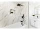 Bright bathroom featuring a soaking tub with luxurious marble tile surround and modern fixtures at 1425 E Diamond St, Phoenix, AZ 85006
