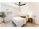 Bright bedroom features a ceiling fan, natural light, and stylish decor on the nightstand and corner table at 1425 E Diamond St, Phoenix, AZ 85006