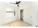 Bright bedroom featuring wood floors, ceiling fan, and sliding closet doors at 1425 E Diamond St, Phoenix, AZ 85006