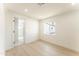 Light-filled bedroom with wood-look floors, ensuite bath, and a window view at 1425 E Diamond St, Phoenix, AZ 85006