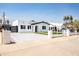 Modern home with white exterior, well-manicured lawn, and a welcoming front entrance at 1425 E Diamond St, Phoenix, AZ 85006