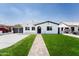 Charming home with fresh landscaping, a brick pathway, and a well-maintained front yard at 1425 E Diamond St, Phoenix, AZ 85006