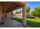 Covered porch overlooks manicured backyard with grassy areas, a gazebo, and a sparkling pool at 14372 W Cypress St, Goodyear, AZ 85395