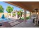 Covered patio leading to backyard with pool, gazebo, and lush landscaping at 14372 W Cypress St, Goodyear, AZ 85395