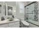 Bathroom features a stylish vanity with a vessel sink and a shower-tub combo with marble-patterned tile surround at 14372 W Cypress St, Goodyear, AZ 85395