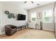 Well-lit bedroom featuring a TV, desk area, and modern decor, creating a comfortable atmosphere at 14372 W Cypress St, Goodyear, AZ 85395