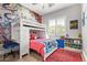Fun, colorful ' bedroom with a bunk bed, desk, and playful wall art at 14372 W Cypress St, Goodyear, AZ 85395