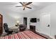 Comfortable bedroom with desk and chair, ceiling fan, striped bedding, and TV at 14372 W Cypress St, Goodyear, AZ 85395