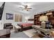 Cozy bedroom with ceiling fan, window, neutral walls, striped bedding, and wooden shelving at 14372 W Cypress St, Goodyear, AZ 85395