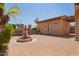 Outdoor courtyard with a decorative fountain, wrought iron gate, and desert landscaping at 14372 W Cypress St, Goodyear, AZ 85395