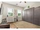 Versatile flex room with a Murphy bed, a small kitchen area, and plenty of natural light at 14372 W Cypress St, Goodyear, AZ 85395