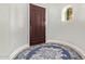 Entryway features a wooden door, wood floors, and a decorative niche at 14372 W Cypress St, Goodyear, AZ 85395
