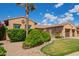 Beautiful landscaping with a mature palm tree accenting the front of this elegant home at 14372 W Cypress St, Goodyear, AZ 85395