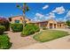Lovely landscaped front yard with a mature palm tree enhancing the curb appeal of the home at 14372 W Cypress St, Goodyear, AZ 85395