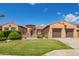Inviting single-story home with a lush green lawn and a convenient two-car garage at 14372 W Cypress St, Goodyear, AZ 85395