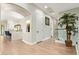 Bright hallway featuring wood floors and an open view of the kitchen at 14372 W Cypress St, Goodyear, AZ 85395