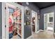 Hallway with storage room, leading to a room with neutral walls and tiled floors at 14372 W Cypress St, Goodyear, AZ 85395