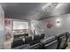 Home theater features tiered seating, projector, screen, and themed decor for immersive viewing experience at 14372 W Cypress St, Goodyear, AZ 85395