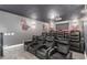 Home theater offers tiered seating, projector, screen, and sports-themed decor for ultimate entertainment at 14372 W Cypress St, Goodyear, AZ 85395
