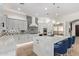 Modern kitchen with an island, elegant lighting, and a stainless steel refrigerator at 14372 W Cypress St, Goodyear, AZ 85395