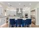 Modern kitchen with an island, elegant lighting, and a stainless steel refrigerator at 14372 W Cypress St, Goodyear, AZ 85395