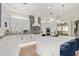 Modern kitchen with an island, elegant lighting, and a stainless steel refrigerator at 14372 W Cypress St, Goodyear, AZ 85395