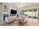 Bright living room with modern furniture, fireplace, and sliding doors to backyard at 14372 W Cypress St, Goodyear, AZ 85395