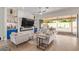 Bright living room with modern furniture, fireplace, and sliding doors to backyard at 14372 W Cypress St, Goodyear, AZ 85395