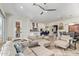 Open-concept living room with comfortable seating with view to the kitchen and dining room at 14372 W Cypress St, Goodyear, AZ 85395