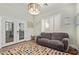 Inviting living room with a comfortable couch, bright colors, and natural light from the french doors at 14372 W Cypress St, Goodyear, AZ 85395