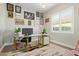 Bright home office with gallery wall, white desk, and a window with great natural light at 14372 W Cypress St, Goodyear, AZ 85395