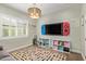Bright playroom with a sofa, toy storage, natural light, and a large TV at 14372 W Cypress St, Goodyear, AZ 85395