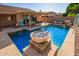 Gorgeous pool with water feature, lounge seating, and patio, great for outdoor entertaining at 14372 W Cypress St, Goodyear, AZ 85395