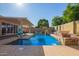 Beautiful pool with water features and an umbrella, perfect for relaxation and outdoor enjoyment at 14372 W Cypress St, Goodyear, AZ 85395