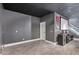 Room features a mini-fridge, sleek countertops, blank walls and gray flooring at 14372 W Cypress St, Goodyear, AZ 85395