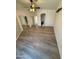 Bedroom features wood-look flooring, mirrored closet doors, and ensuite bathroom at 14602 S 47Th St, Phoenix, AZ 85044