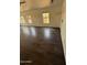 Living room featuring wood-look floors, natural light, and ample space for relaxation and entertainment at 14602 S 47Th St, Phoenix, AZ 85044