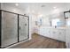 Bright bathroom featuring a glass shower and double vanity at 14825 W Whitehorn Way, Surprise, AZ 85387