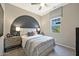 Bedroom featuring a large decorative headboard, side tables with lamps, and a comfortable queen bed at 14825 W Whitehorn Way, Surprise, AZ 85387