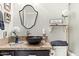 Bathroom vanity with granite countertop, vessel sink, and decorated shelves at 14826 N 92Nd Pl, Scottsdale, AZ 85260